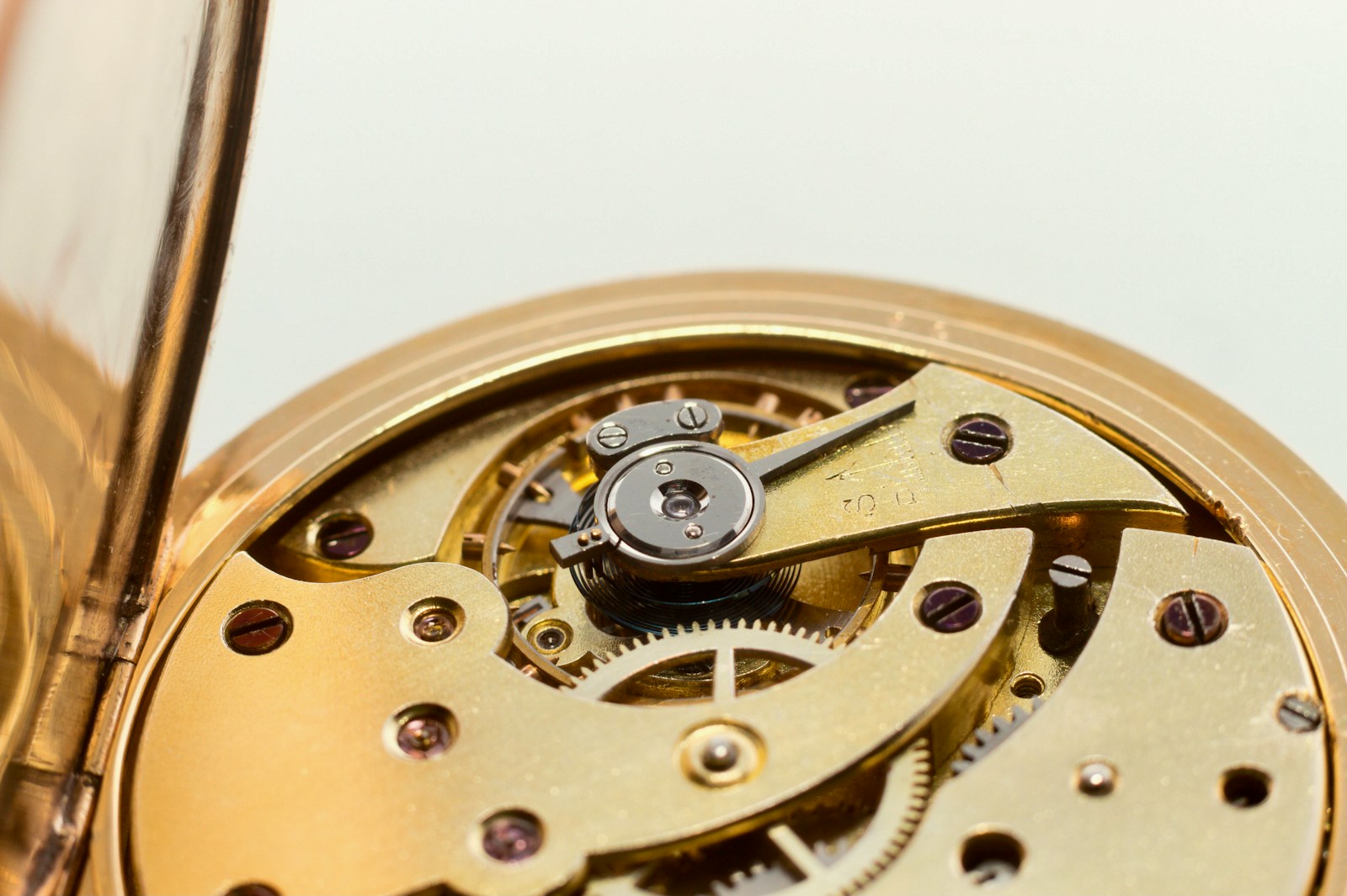 A close up of a gold pocket watch